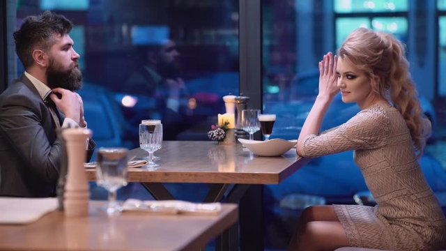 Beautiful couple in a restaurant. Romantic couple dating in pub at night. Couple have romantic evening in restaurant.
