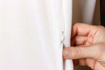 Bridal Gown Fitting. seamstress prepares dress to the fitting