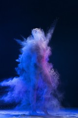 Obraz na płótnie Canvas Male figure shot fully in a cloud of blue dust