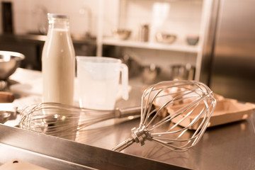 close up view of ingredients for dough and kitchen utensils on counter in restaurant