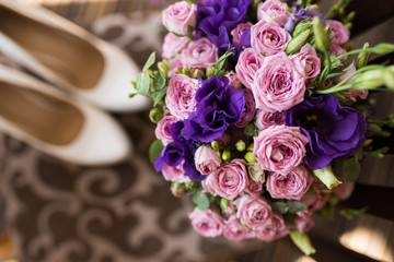 Bridal bouquet with pink and purple flowers. Wedding preparation. Wedding accessories. Bride`s morning. Wedding photo
