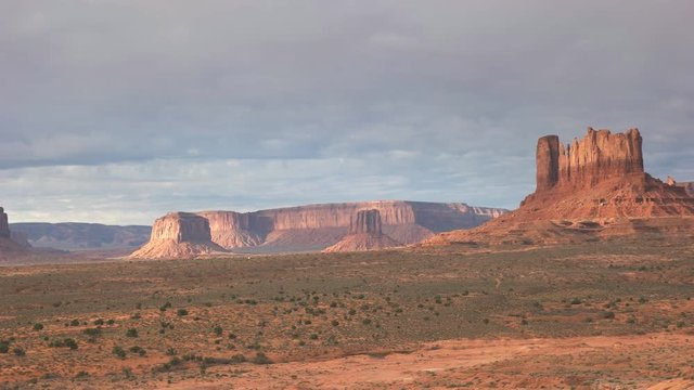 a morning panning shot of saddleback mesa at monument valley in utah, usa