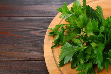 Fresh green parsley on the wooden table, selective focus.
