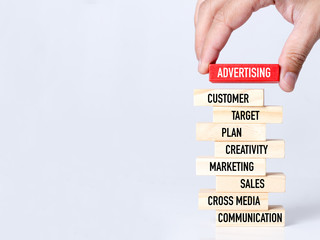 Businessman Building ADVERTISING Concept with Wooden Blocks