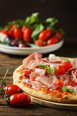 Italian pizza with mozzarella, tomato and bacon