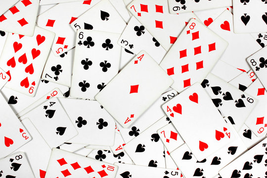 Ace of diamonds on top of red and black playing cards