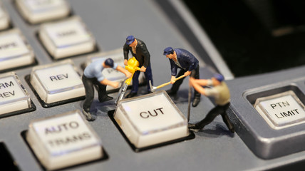 Miniature people : worker on switcher control of Television Broadcast,color buttons.