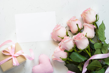 Pink rose at white stone table.