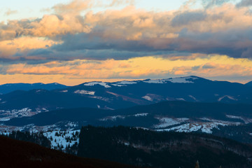 Sunset in winter mountains after blizzard