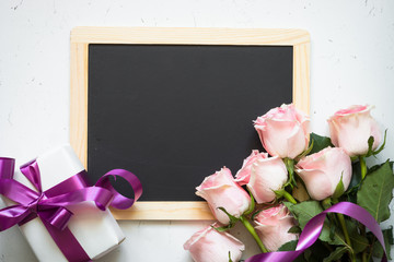 Pink rose present and chalkboard