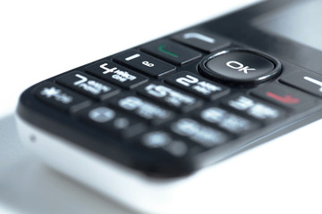 Старый кнопочный телефон на белом фоне. Old push-button telephone on a white background 