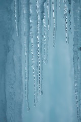 Plakat A frozen waterfall with ice in a blue and white color in winter