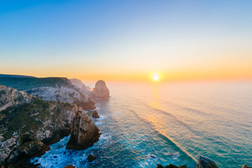 Amazing stunning unbelievable sunset at atlantic ocean in Portugal. Cape Rock fantasy seascape....