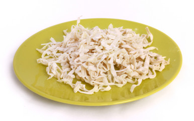 homemade noodles from dough on a round plate isolated on white background