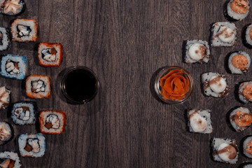Sushi backdrop background. Sushi rolls are located on the table in the form of triangles.