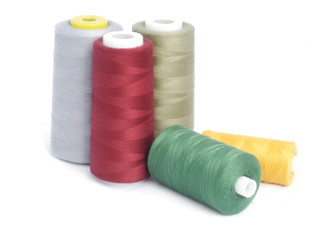 sewing thread in reels isolated on white background