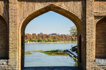 Isfahan, Iran - November 25, 2015: View over the Zayanderud River through one of the archs of Sio-Se-Pol Bridge in Isfahan