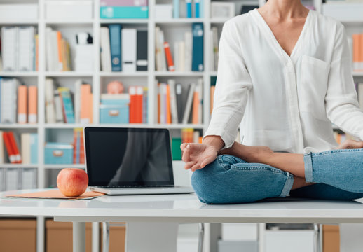 Woman Practicing Meditation On A Desk