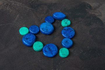 Decorative blue stones shaped heart on a dark background