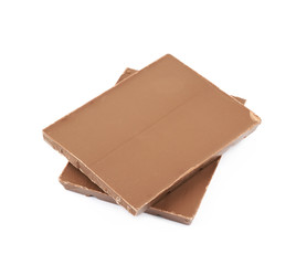 Pile of milk chocolate pieces isolated