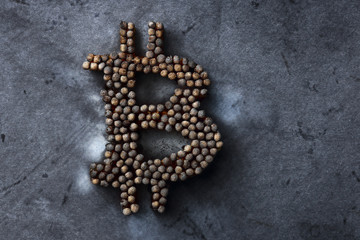 Burnt bitcoin sign on a metal texture, the concept of a crypto currency crash