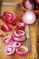 Red fresh onion and knife on the table