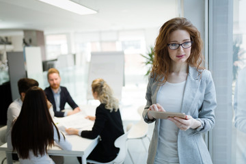 Young female architect using digital tablet in office