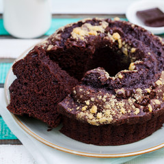 Chocolat bundt cake. Colorful wooden background.