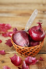 Red fresh onion and knife on the table