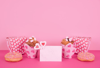 Muffins in colorful paper baking cup with red hearts.