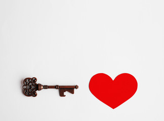 Key to your heart, Open and Unlock your heart, Valentine's Day Concept, vintage key and red heart made from paper on white paper background, eternal love, negative space for text