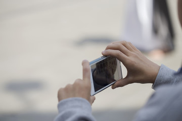 A boy is taking a photo of a procession. Holy week.