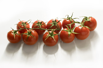 Small vine tomatoes isolated on white background - high angle view