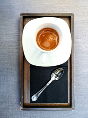 white cup of hot coffee on table