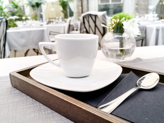 white cup of hot coffee on table