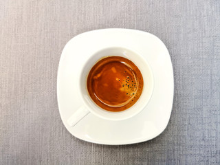 white cup of hot coffee on table