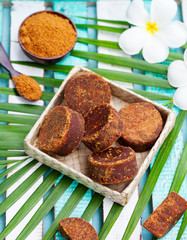 Palm sugar with palm leaf and flowers. Top view.