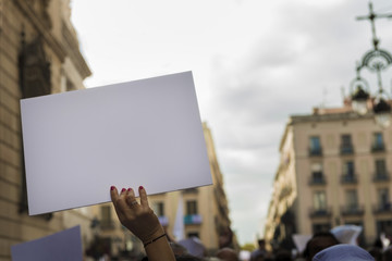 woman's hands holding banner during demonstration