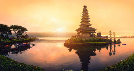 Pura Ulun Danu Bratan, Hindu temple with boat on Bratan lake landscape at sunrise in Bali,...