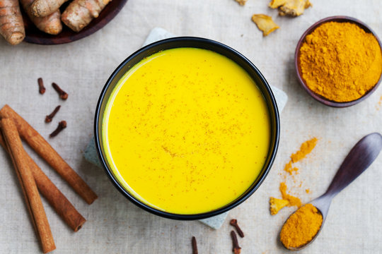 Turmeric drink, latte, tea, milk. Top view.