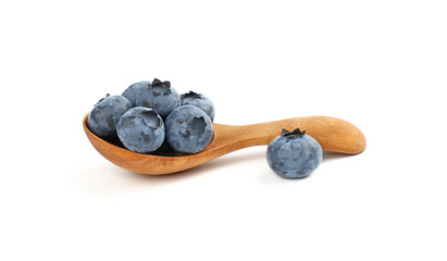 Fresh blueberry in wooden spoon isolated on white
