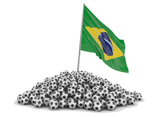 Pile of Soccer footballs and Brazilian flag. Image with clipping path