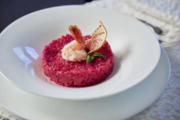 red risotto with shrimps and lemon restaurant dish