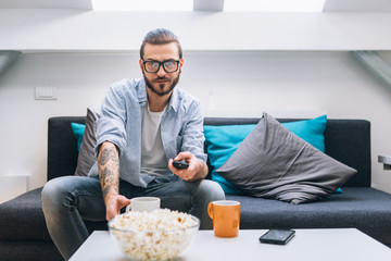 Man sitting on couch and watching tv