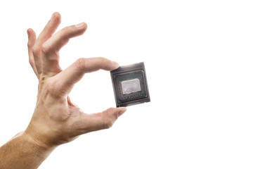 Delidded CPU with old thermal paste and glue in man's hand isolated on white background.