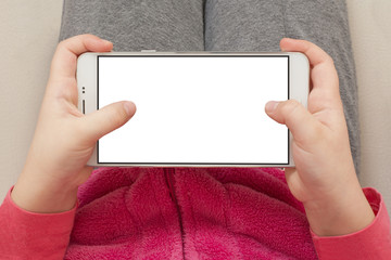 Little girl holding smartphone in horizontal position with isolated screen. Kid play game, surfing...