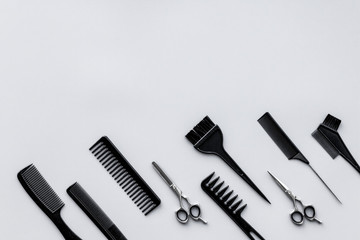 Beauty saloon equipment. Hairdress, haircut. Combs, sciccors, brushes on grey background top view copy space