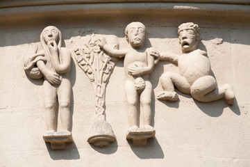 Mediveal sculpture of the 13th century, showing adam and eve eating from the tree of knowledge 