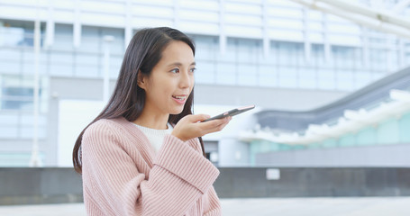 Woman sending audio message on cellphone