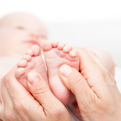 Little baby receiving chiropractic or  osteopathic foot massage